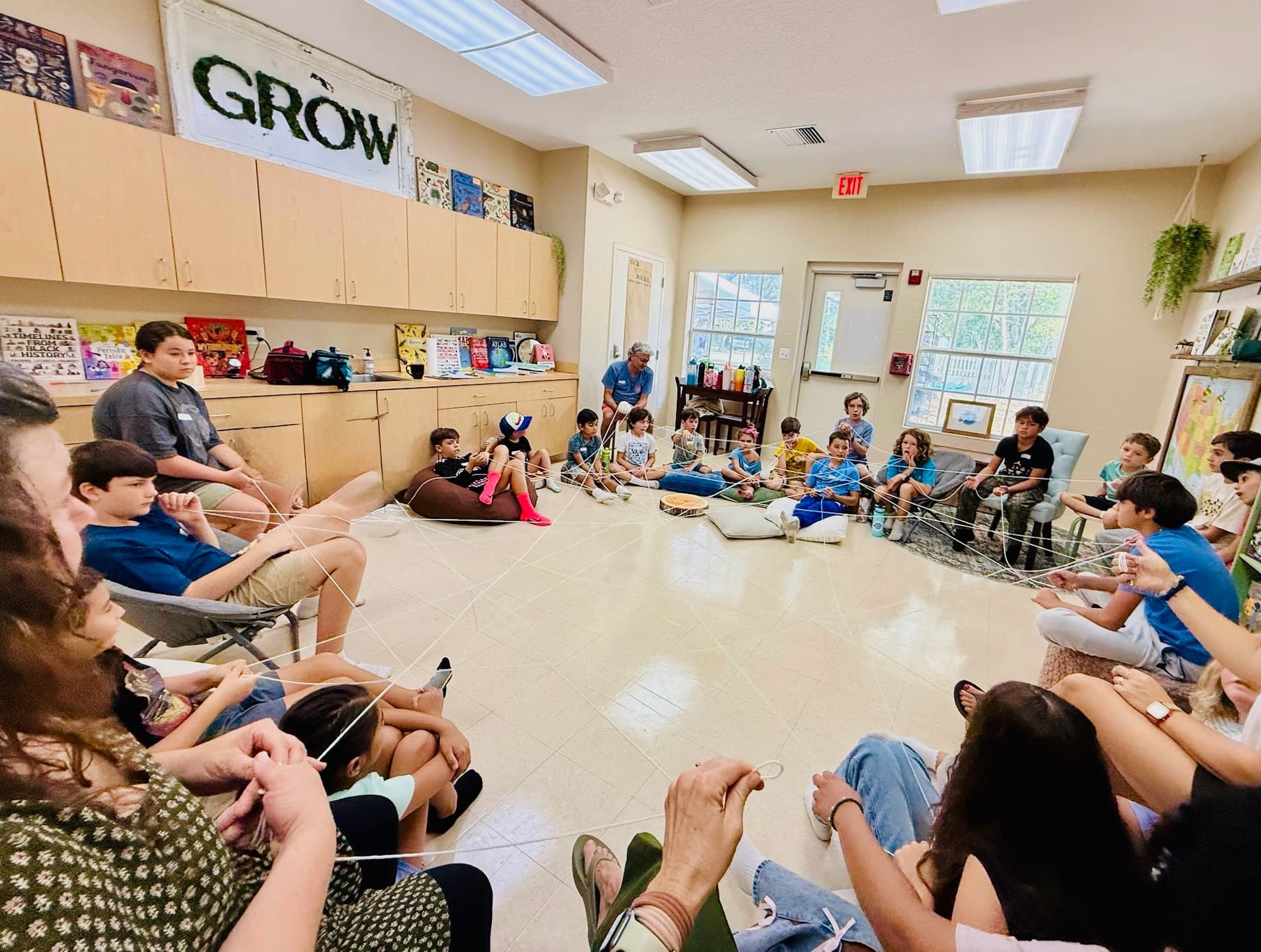 The full Grow Co-op community in a circle in the classroom